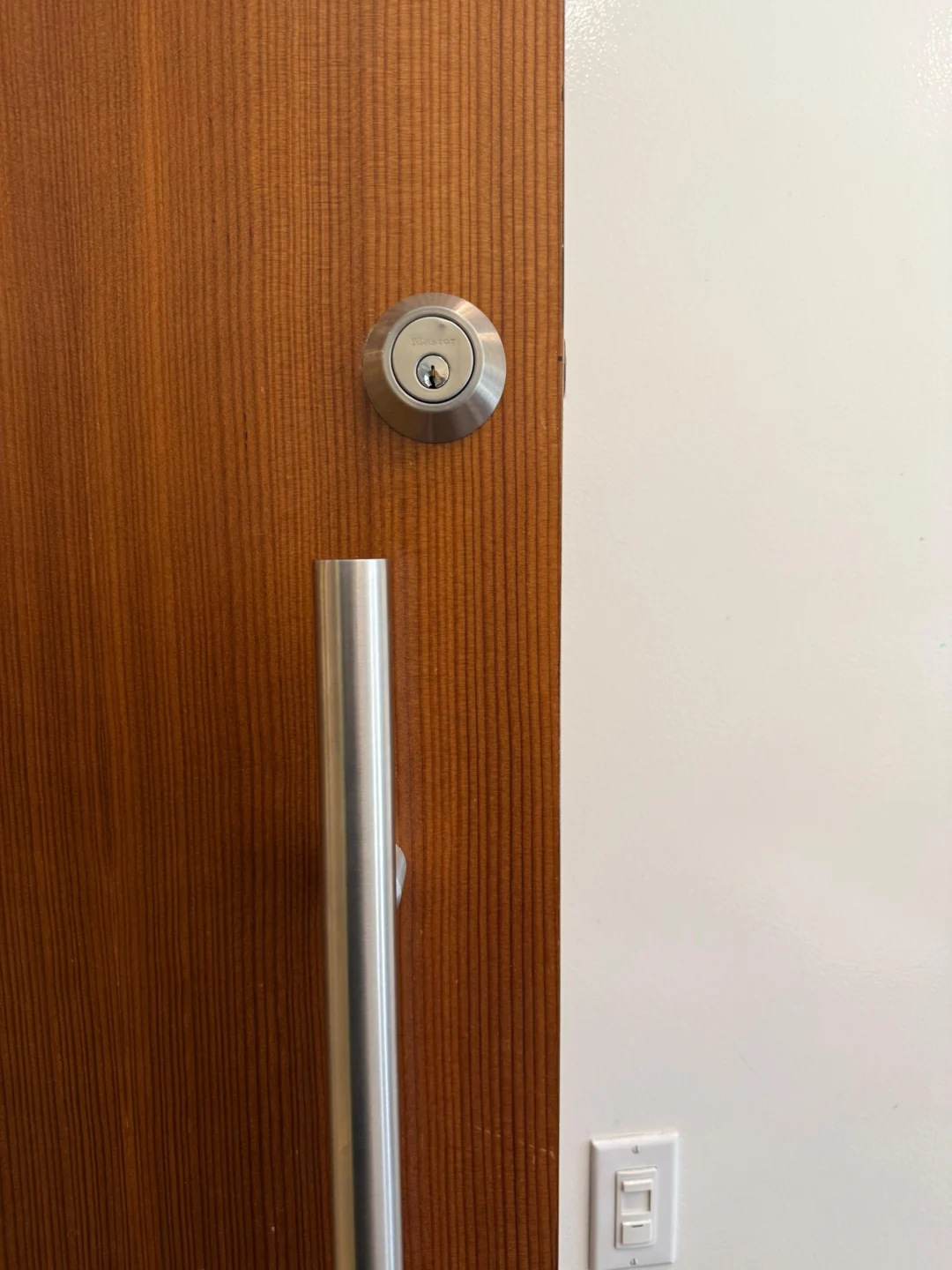 Deadbolt lined up with the strike plate on a wood door in NYC