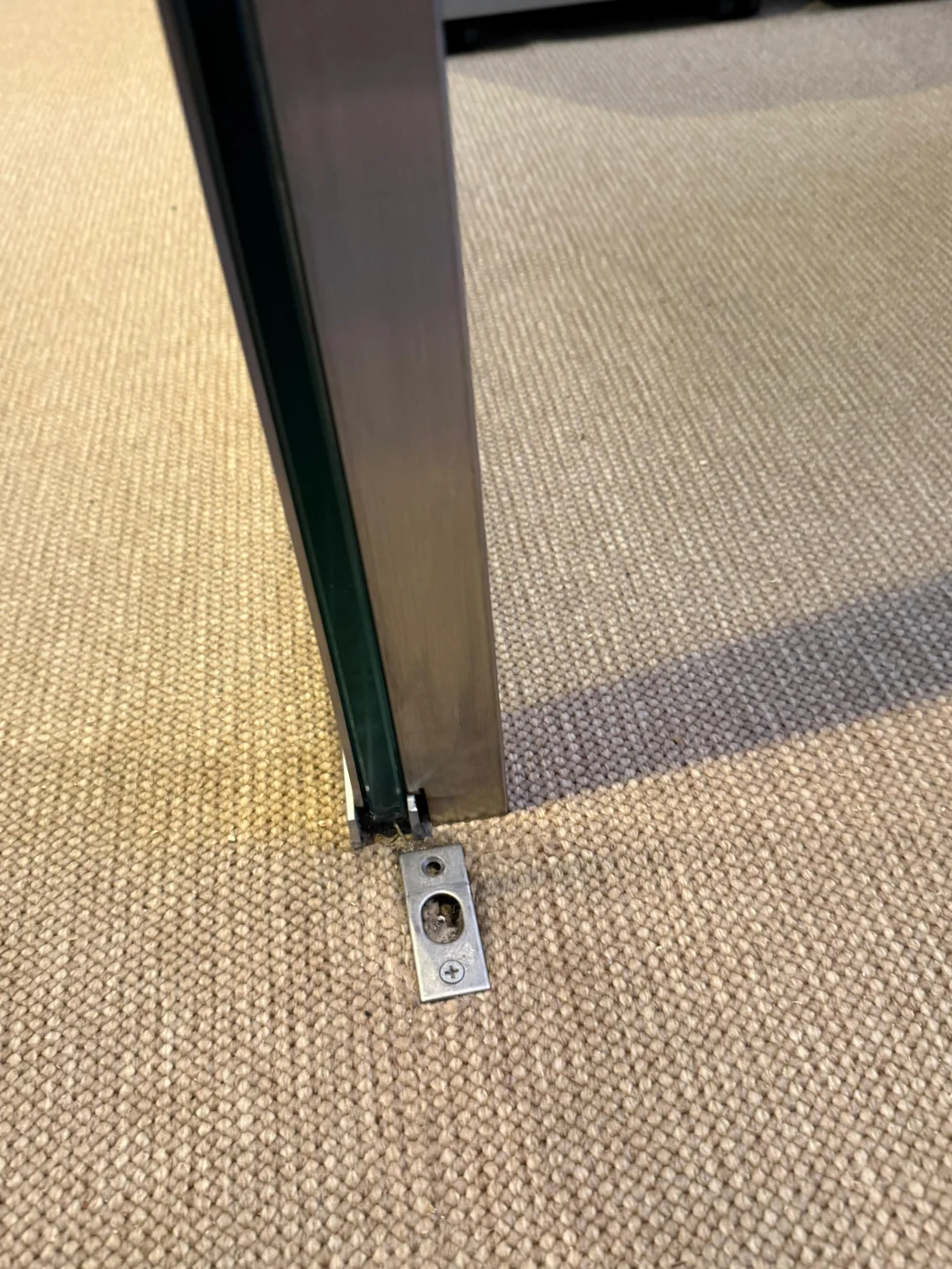 Floor closer and bottom pivot fitting on a swing glass door in NYC