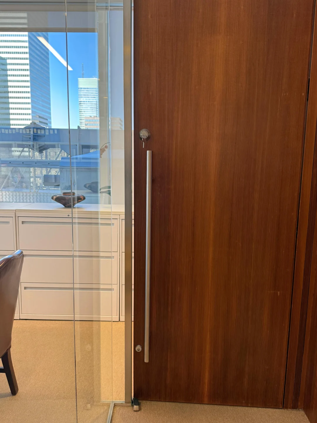 Glass office door with pull handle after a lock installation in NYC