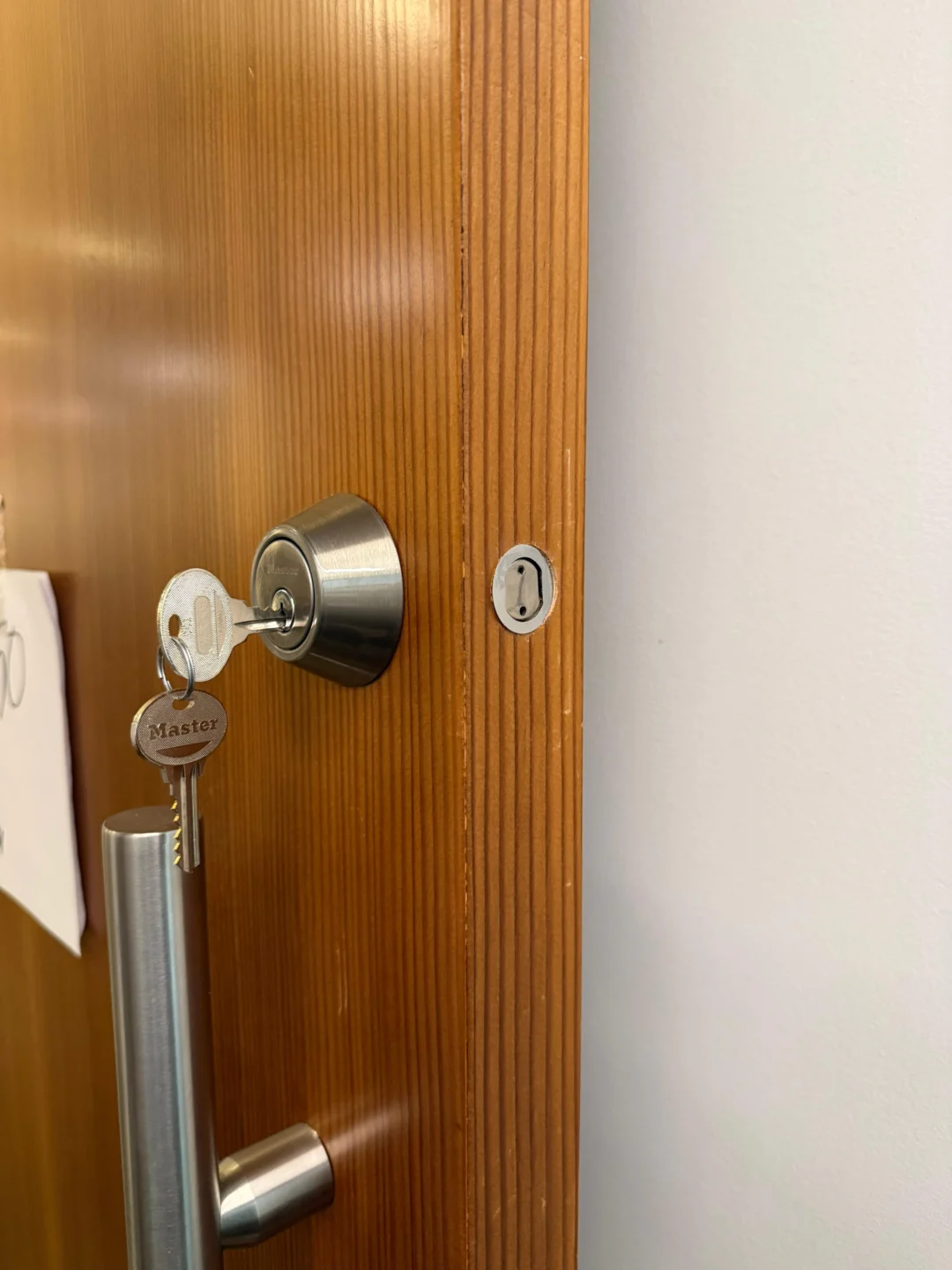Locksmith replacing a high-security lock cylinder on an office door in NYC