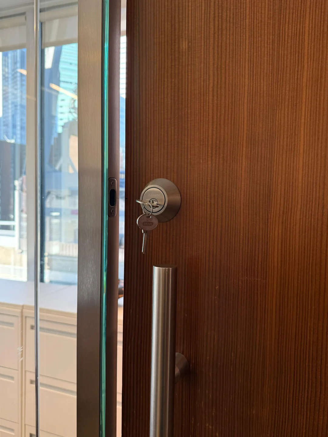 Deadbolt cylinder inspected on a wood door in NYC