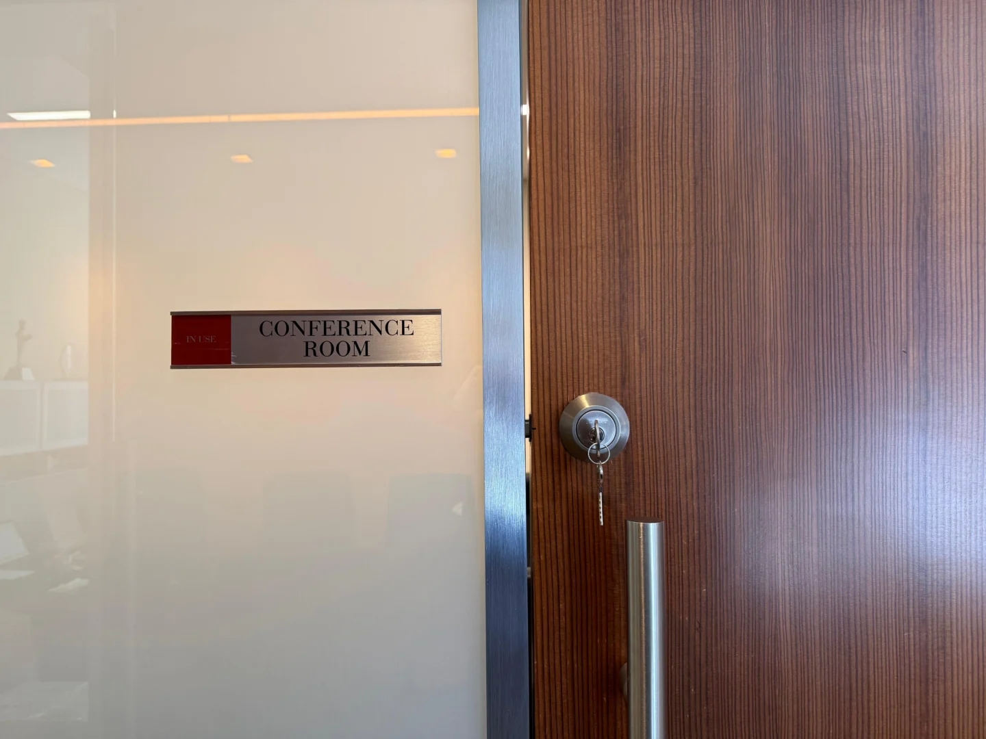 Mortise cylinder with key on a wood conference room door in NYC