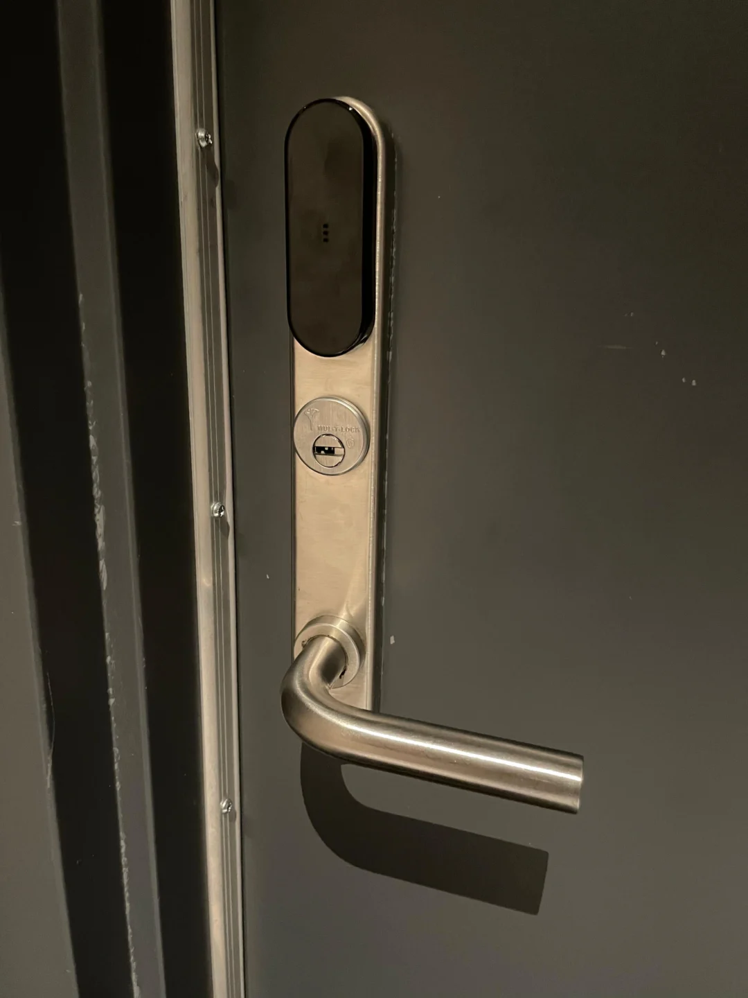 Commercial mortise lock with lever trim on a metal door in NYC