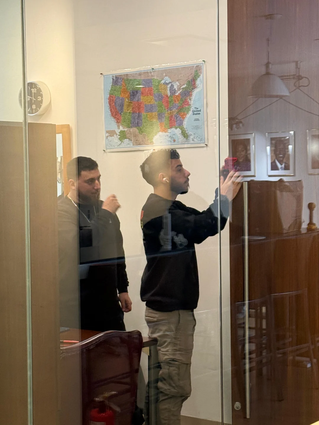 Rainbow Locksmith technician adjusting a swing door closer on a glass office door in NYC